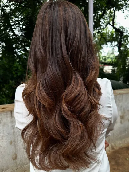 Getting ready for 'Ghar ki shaadi' (a home wedding). This client wanted a glamorous but natural look, so I gave her a rich color melt with soft waves, perfect for the occasion.
