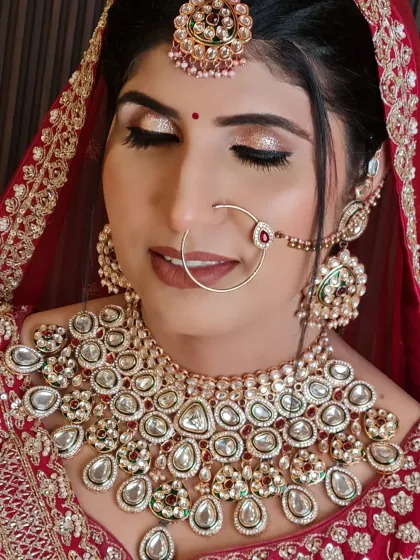 A pretty bride with stunning glittery eyes. This close-up shows the detail of her eye makeup and her beautiful kundan jewelry.