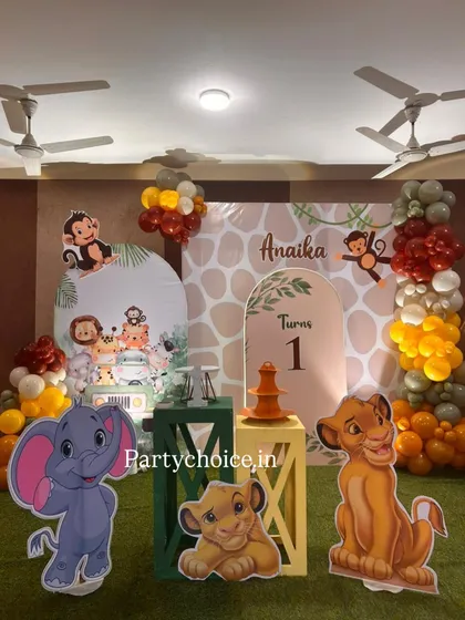 A closer look at the details of our jungle theme decor, showing the custom arched backdrops and character cutouts of Simba, Dumbo, and monkeys that make the setup so engaging for children.