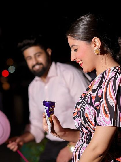 A fun, candid shot capturing a sweet moment with a chocolate and a smiley balloon, showing that even in the grandest locations, it's the small, personal touches that matter.