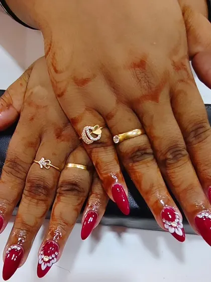 This full view shows the complete set of bold red stiletto nails I created for a bride. The intricate 3D art and glitter accents make this a truly show-stopping look.