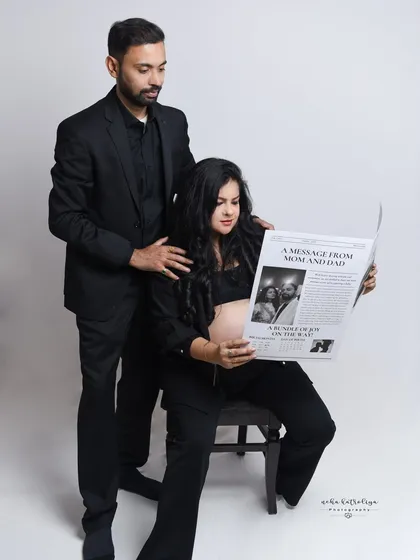 Another take on the newspaper prop, this time with the mother-to-be seated. I always try a variety of poses during a session to give you a wide selection of images for your final gallery.