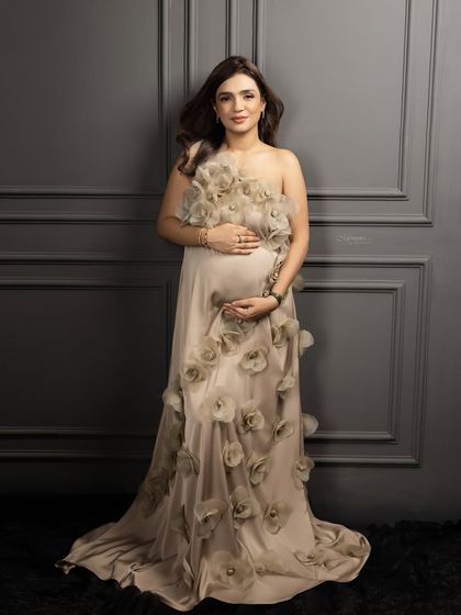A full-length view of this stunning floral gown, showing how we can create a look that is both elegant and deeply personal for your maternity session.