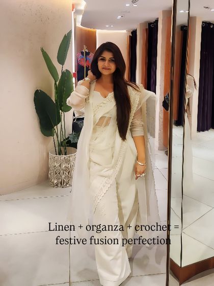 A closer look at the layering of linen, organza, and crochet. This is a perfect example of how to create a festive fusion look that is both elegant and comfortable.