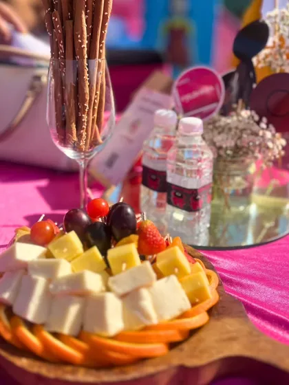 A cheese and fruit platter from the 'Squid Game' themed event. Even simple, fresh offerings are presented beautifully to complement the overall vibrant and exciting atmosphere of the party.