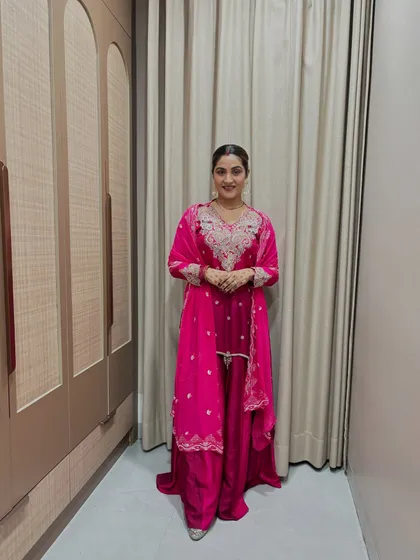 A full-length view of the pink sharara. The monochromatic look is elongating, and the intricate silver embroidery adds a touch of royalty.
