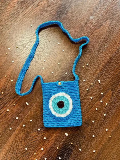 This trendy Evil Eye crossbody bag is perfect for a casual day out. It's just the right size for your essentials and adds a cool, protective symbol to your look.