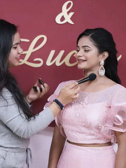 A behind-the-scenes moment, showing the application of face powder to set the makeup for a long-lasting, photo-ready finish.
