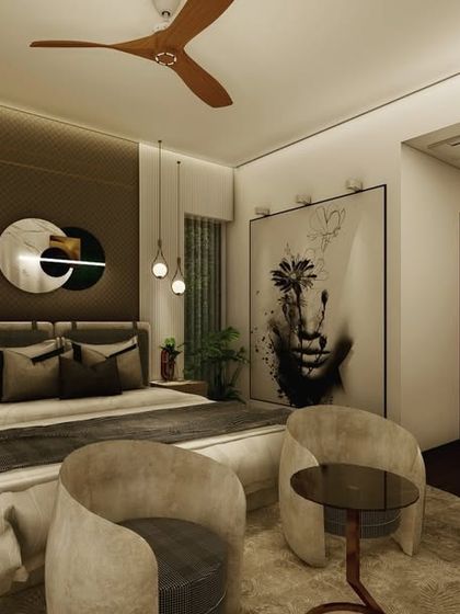 This bedroom features bold, artistic elements, including a large portrait and abstract mirrors. The design combines a dark, moody color palette with warm lighting and comfortable seating to create a sophisticated and personal space.