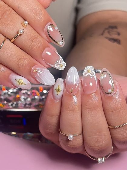 Nails that speak louder than words. A beautiful white ombre set with seashell textures and 3D floral details, perfect for a summer holiday.