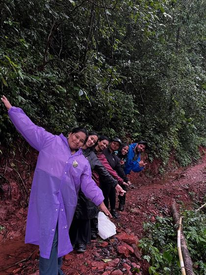 A fun "train" of trekkers posing on a muddy trail in Kodachadri.