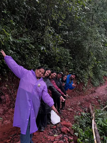A fun "train" of trekkers posing on a muddy trail in Kodachadri.