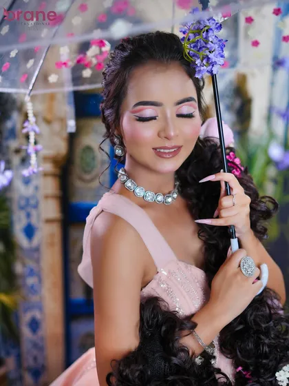 The floral umbrella prop adds a whimsical and romantic touch to this fairytale-themed shoot.