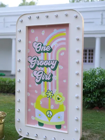 Another angle of the "One Groovy Girl" marquee sign, showing its bright lights and playful 70s-inspired graphics.