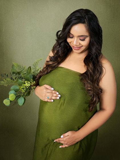 A simple, beautiful portrait using a green fabric wrap, focusing on the natural beauty of the mom-to-be.