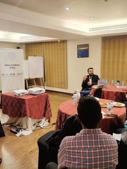 Leading a discussion with fellow doctors about new skincare formulations, including skin barrier topicals and treatments for acne and pigmentation.