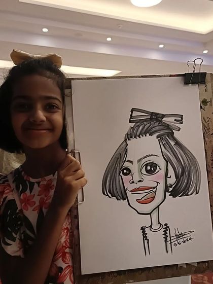 A girl with a big bow in her hair, and a caricature to match. These little details make the drawing so much more personal.