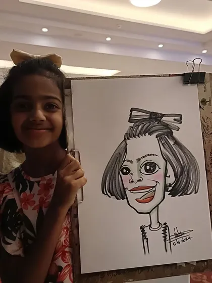 A girl with a big bow in her hair, and a caricature to match. These little details make the drawing so much more personal.