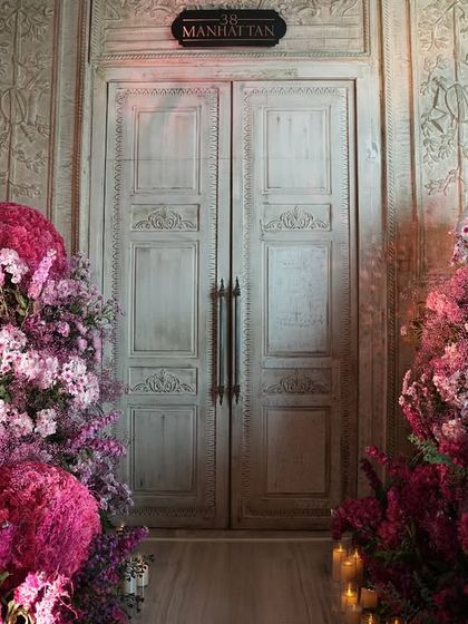 A closer look at the entrance to the "Manhattan" room, framed by beautiful pink floral arrangements. The soft lighting and the sheer volume of flowers create a fairytale-like welcome for the Mehendi guests.