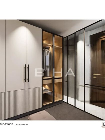 Adjacent to the washroom, this walk-in closet area features glass-paneled wardrobe sections for displaying select items. The combination of closed and open storage, along with integrated lighting, creates a functional and luxurious dressing experience.