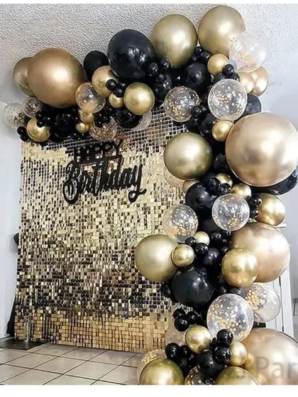 This is a classic and elegant black and gold theme, perfect for any sophisticated celebration. The design features a full organic balloon arch over a shimmering gold sequin wall, creating a perfect photo backdrop for guests.
