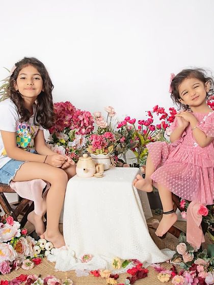Two sisters enjoying a beautiful day at their floral tea party. We love creating these imaginative and playful setups for sibling photoshoots.