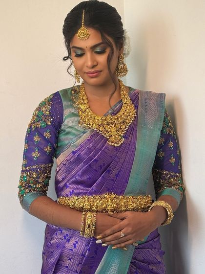 My beautiful bride Abi showcasing her colourful reception look. Her makeup features my signature eye makeup with a pop of blue, perfectly complementing her purple and teal saree.