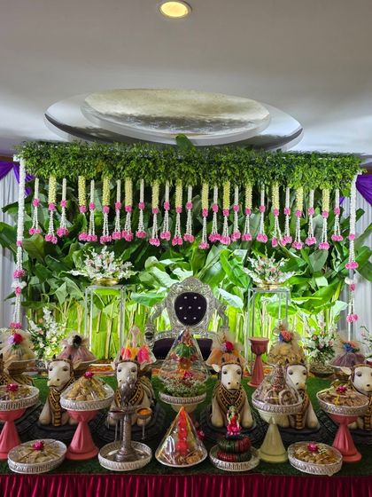 A full view of the stage with the green backdrop and pink floral accents.