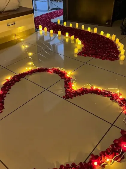 A view from above of the romantic rose petal pathway and heart, illuminated by fairy lights.