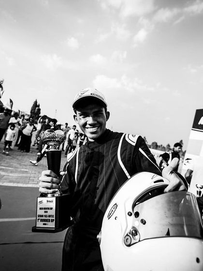 A black and white shot of a driver celebrating a win.