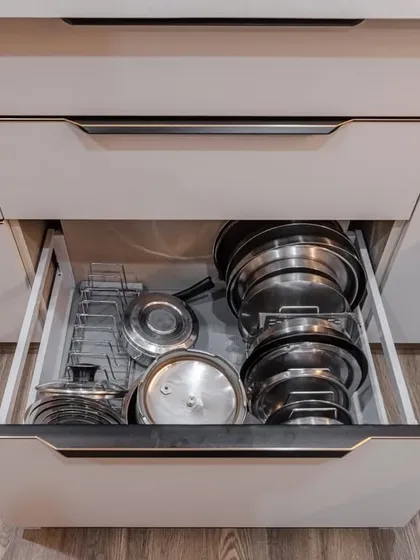Our drawers are designed for heavy use. This image from the Kohinoor Square project shows a deep drawer with an organizer for pots and pans, ensuring your cookware is always tidy and accessible.