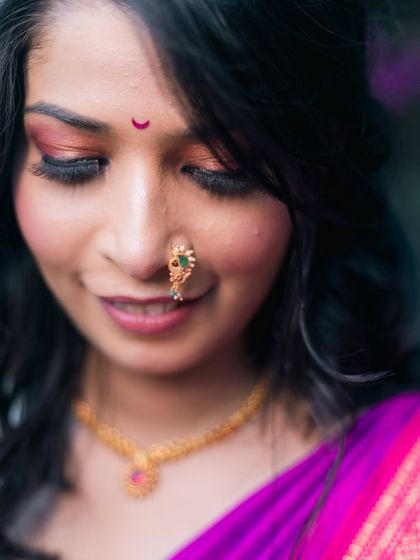 A close-up of a bride's beautiful makeup and traditional nose ring.