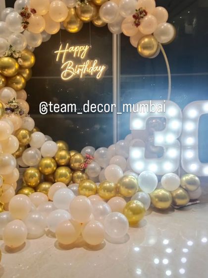 The 30th birthday decor from a different angle, showing how the marquee numbers and balloon arch create a complete photo-ready scene.