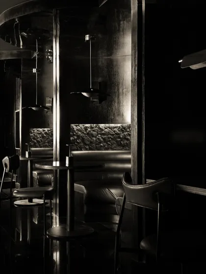 Reflections and shadows in the main dining area, where polished surfaces and dark corners create a constantly shifting visual landscape.