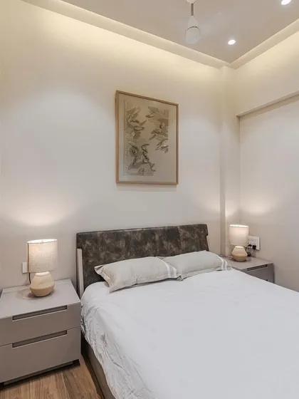 This angle highlights the clean lines of our modular bed and side tables. The neutral color palette and minimalist design create a calming sanctuary, perfect for unwinding after a long day.