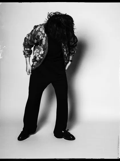 A dynamic black and white shot of Taba Chake, with his hair in motion. It captures his energy and the feeling of being lost in the music.