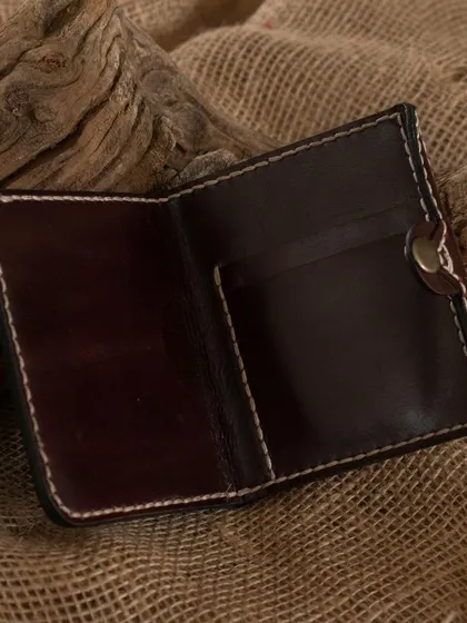 An open view of a handcrafted leather wallet, showcasing the kind of item participants can learn to make in our leather craftsmanship workshop.