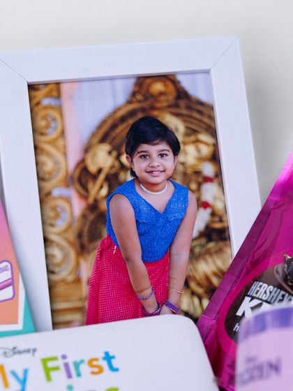 A framed photo of the birthday girl is the centerpiece of this personalized hamper, making the gift all about her.