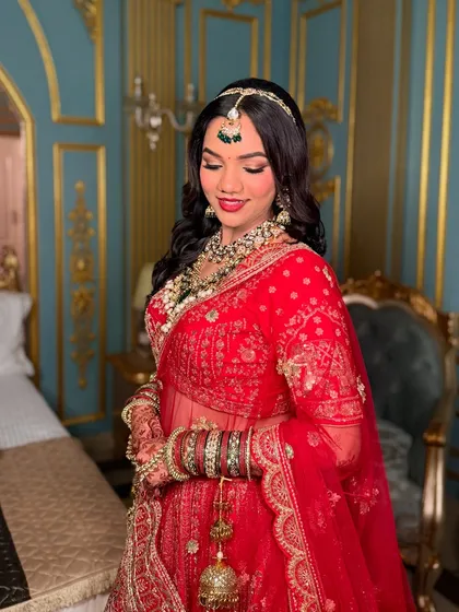 A moment of quiet reflection for the bride. The makeup is set to look flawless from every angle, capturing the emotion of the day.