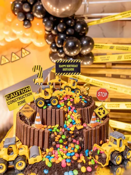 My dessert tables are a feast for the eyes and the tastebuds. This construction-themed dirt cake is a perfect example, featuring chocolate dirt, edible boulders, and toy bulldozers, making it a delicious and interactive centerpiece.