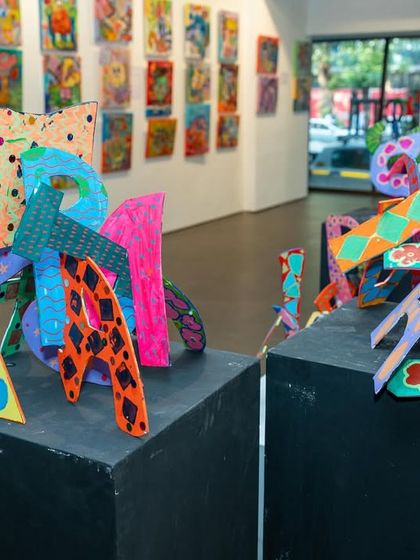 A vibrant, three-dimensional letter sculpture from our student exhibition. This piece showcases how we encourage students to play with form, pattern, and color, pushing their creativity beyond the two-dimensional canvas.