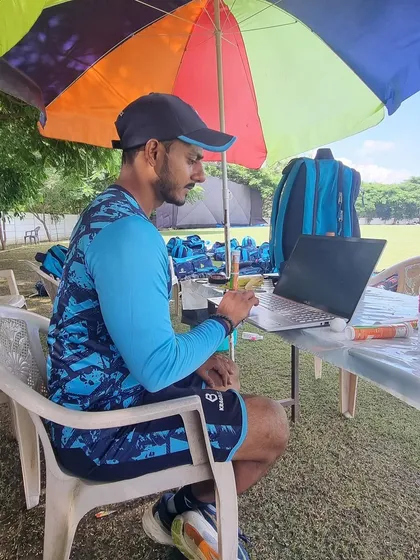 Even on the field, the work doesn't stop. Analyzing data and planning sessions on my laptop.