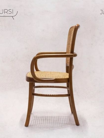 The 'Jawa' chair, a vintage classic. Its bentwood teak frame and rattan surfaces are a nod to timeless European cafe chairs, built with the durability of solid teak.