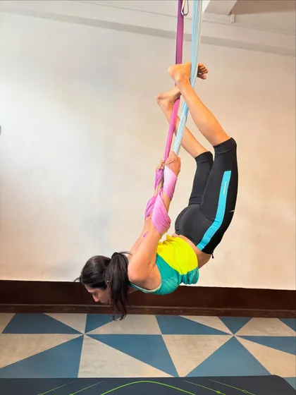 With consistent practice, you'll discover new levels of flexibility and strength. This deep stretch uses the aerial silk to help open the hips and lengthen the spine in a way that's difficult to achieve on the mat.