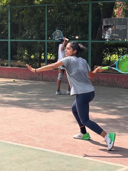 A dynamic shot of a player executing a forehand on the run. We encourage an athletic and energetic style of play.