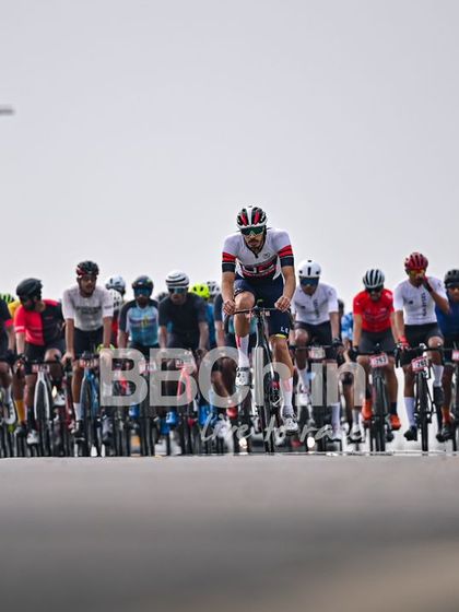 The peloton from a distance, showing the race unfolding on the open road.