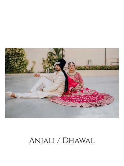A royal-looking portrait of the couple sitting back-to-back, showcasing their traditional wedding attire.