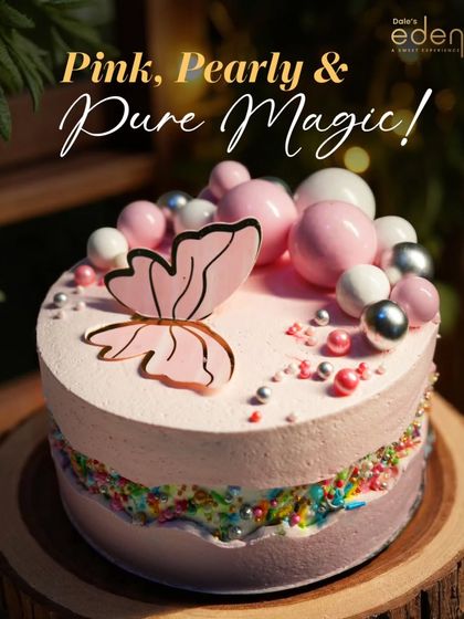 Pink, pearly, and pure magic. This whimsical cake is decorated with a beautiful butterfly, pastel pink frosting, and bubble-like spheres, creating a dreamy and enchanting look.