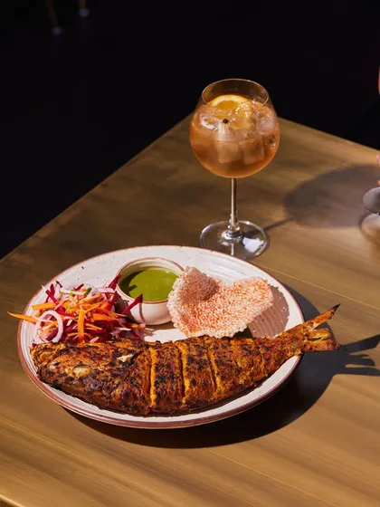 A beautifully plated whole Red Snapper, marinated and cooked to perfection. This is an ideal main course for a celebratory dinner, impressive in both presentation and taste.