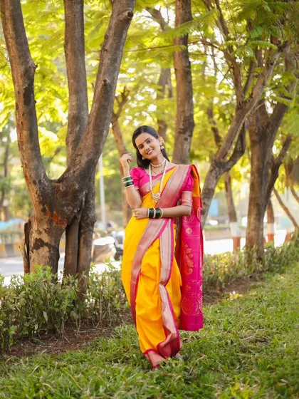 A classic full-length pose that showcases the traditional Maharashtrian bridal look.